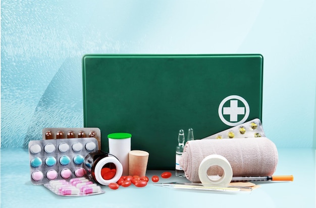 First aid kit  with medical supplies on light background