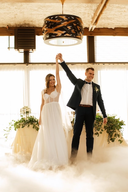 The first dance of the bride and groom inside a restaurant