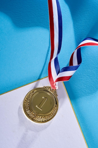 First golden medal on blue background