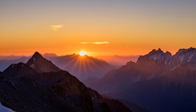 Photo the first light of day breaks over a mountain range with the peaks glowing in the warm hues of dawn