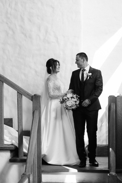 the first meeting of the bride and groom on a wooden staircase