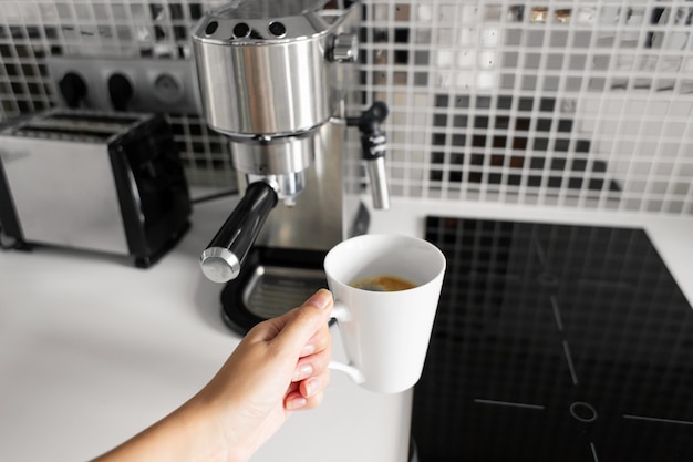 First-person view of a girl preparing delicious aromatic coffee in a coffee machine