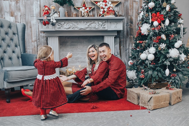 First steps of little girl at home with Christmas decoration