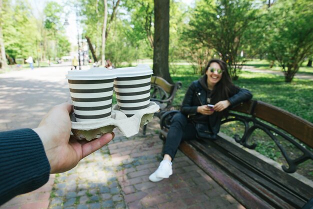 firstperson view man bring coffee to woman coffee to go