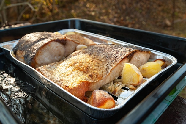 Fish baked with vegetables Pieces of fried fish with vegetables on deco Cooking homemade food