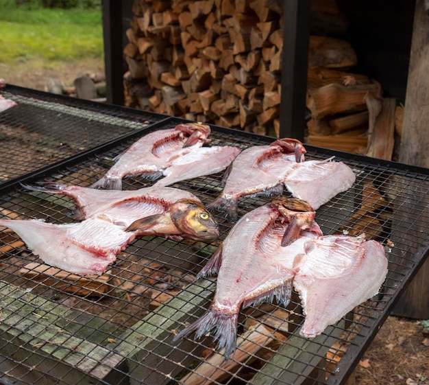 Fish bream prepared for smoking on a grill