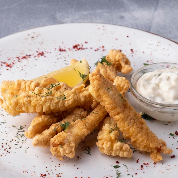 Fish in dough with tartar sauce and lemon