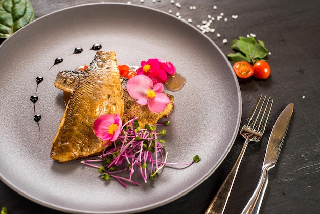 Fish fillet with vegetables on wooden background