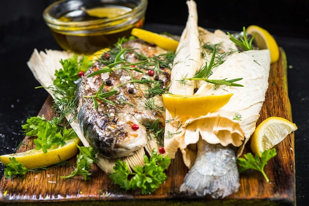 Fish grilled and served in corn husk with herbs