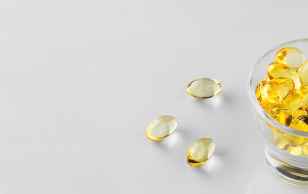 Fish oil capsules in a glass bowl