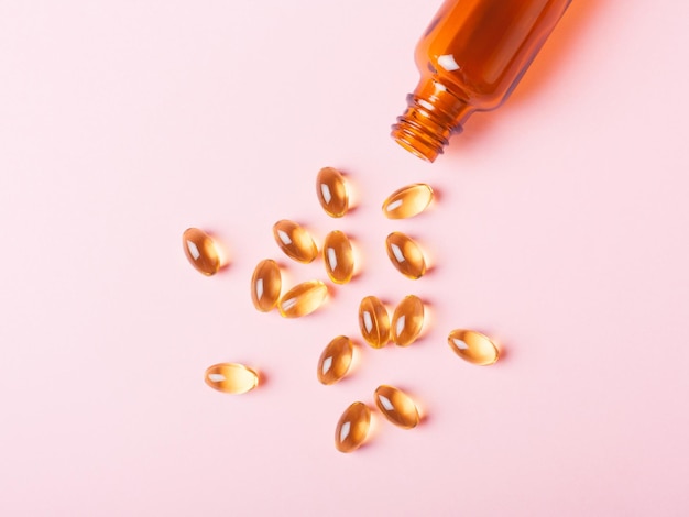 Fish oil capsules omega3 on a pink background