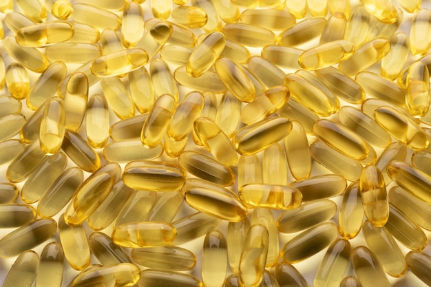 Fish oil Pile of capsules Omega 3 background Close up top view