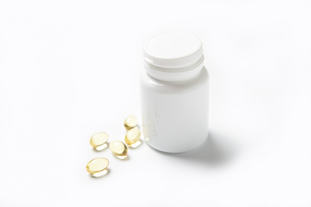 Fish oil pills in a jar on a white. Omega 3. Vitamins