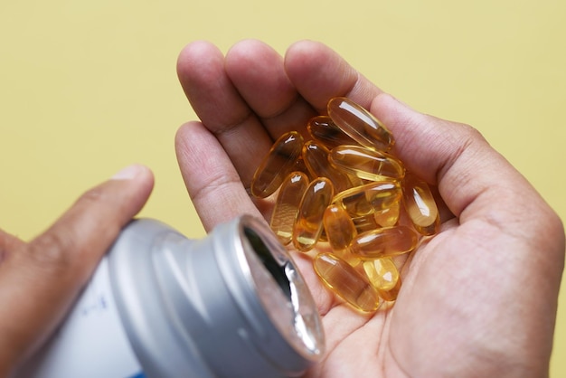 Fish oil supplement on hand top view