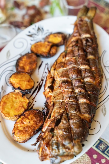 Fish and potatoes cooked in traditional Turkish and Caucasian tandoor