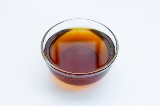 Fish sauce in glass bowl on white surface