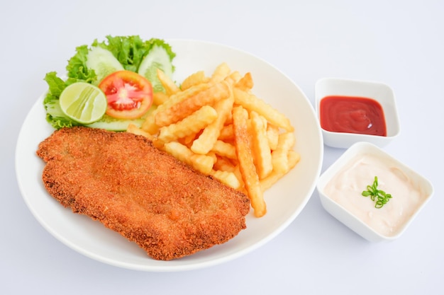 Fish schnitzel with fries isolated on white background