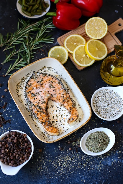 Fish steak with herbs on a tray with vegetables