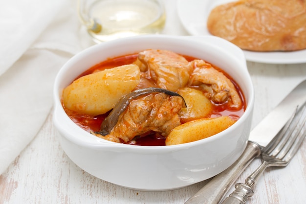 Fish stew on white bowl on wooden surface