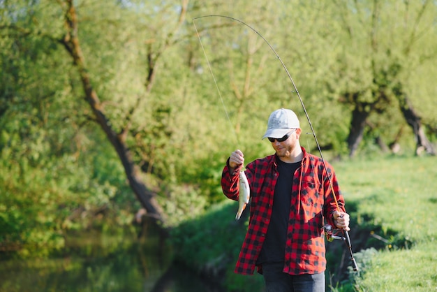 Fisherman by the river with a catch of fish