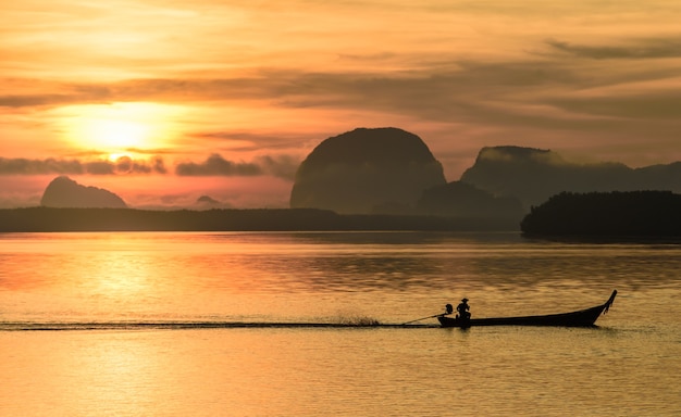 Fisherman on local fishing boat at Samchong fishing village on sunrise in Phang-Nga,Thailand