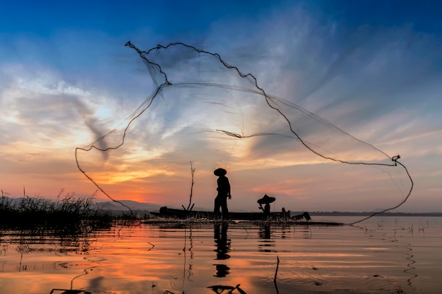 Fisherman in the morning with wooden boats, old lanterns and nets