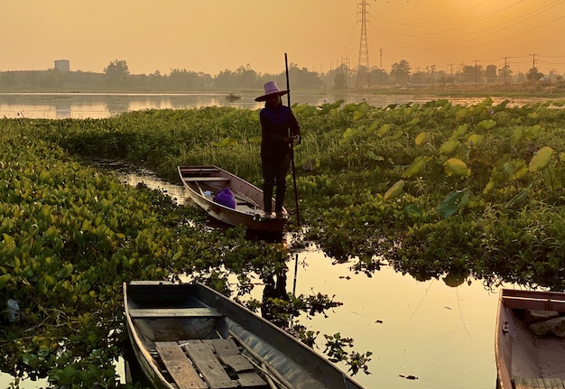 Fisherman oar wooden boat in sunset