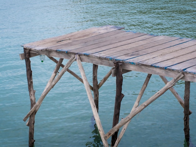 Fisherman's wooden log terrace leading into the sea