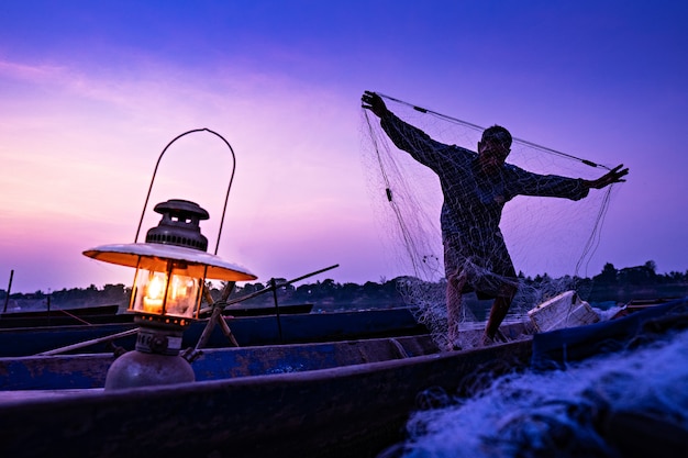 Fisherman working on the boat in the evening.