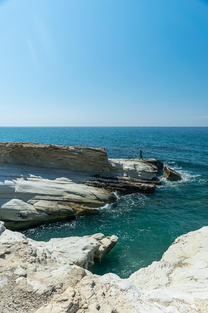 Fishermen are fishing on the seashore Coast of white stones