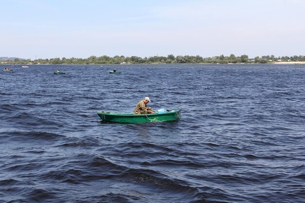 Fishermen on boats catch fish in the river