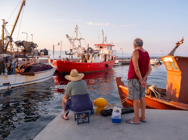 Fishermen and Fishing boats in the port of Loutra Edipsou on island Evia in Greece