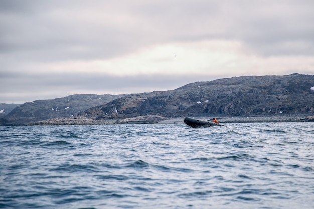 Fishermen sail on a boat in the northern sea