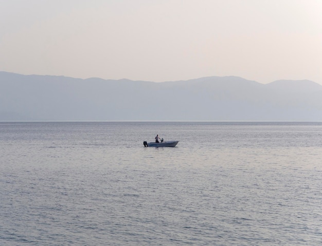 Fishing boat and fishing at sunset in the Aegean Sea near the island of Evia in Greece