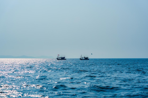 Fishing boat floating on blue sea