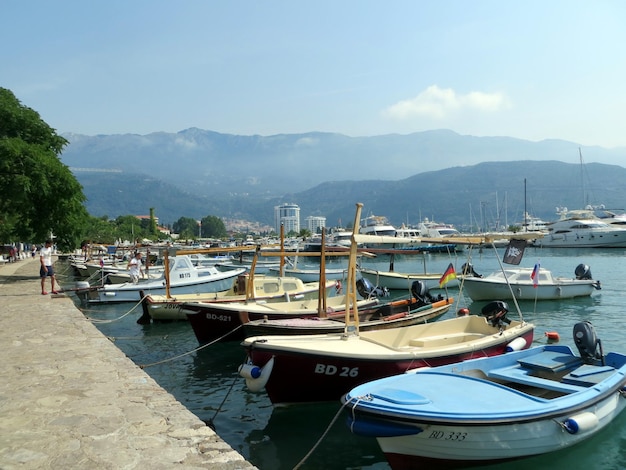 Fishing boats are moored pier near the promenade of the city of Budva Montenegro