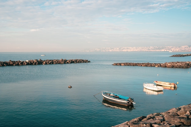 Fishing boats floating on the Mediterranean sea shore. Italy. Seascape.