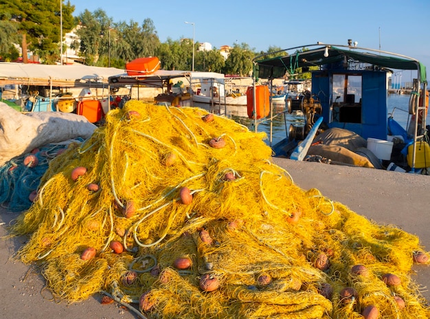 Fishing nets and boats in the port of Loutra Edipsou on island Evia in Greece