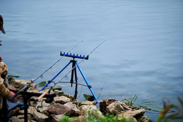 Fishing rod on a stand on the river bank while fishing