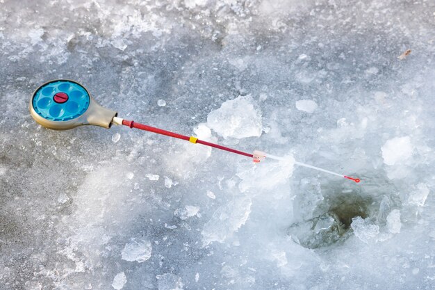 Fishing rod for winter fishing lies on ice