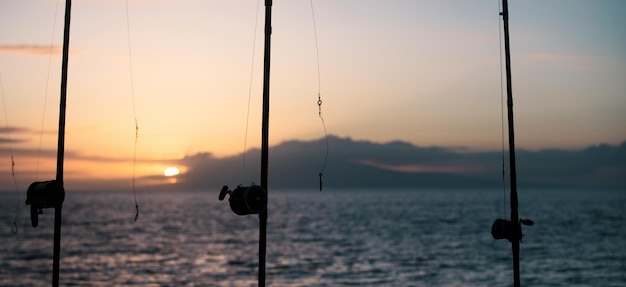 Fishing rods and fishing gear on the ocean coast close up