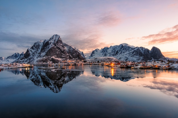 Fishing village with snow mountain at sunrise in Reine, Lofoten, Norway