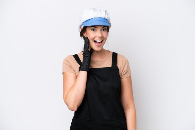 Fishmonger brazilian woman wearing an apron isolated on white background with surprise and shocked facial expression