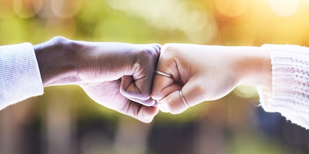 Fist bump diversity and hands of people in park for support agreement and collaboration in nature Friends greeting and closeup of hand gesture for friendship community and solidarity outdoors