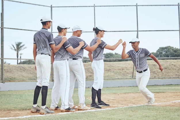 Fist bump teamwork and sport team support in baseball game on pitch field outdoors Baseball player running and excited for fitness exercise training match or sports trust workout in urban city