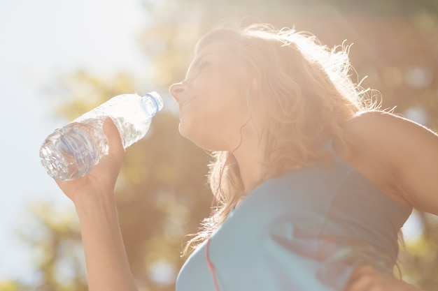 Fit blonde drinking from her water bottle