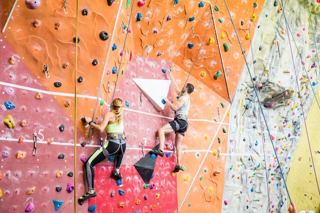 Fit couple rock climbing indoors 