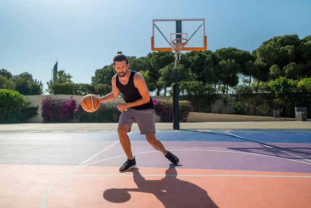 Fit male playing basketball outdoor