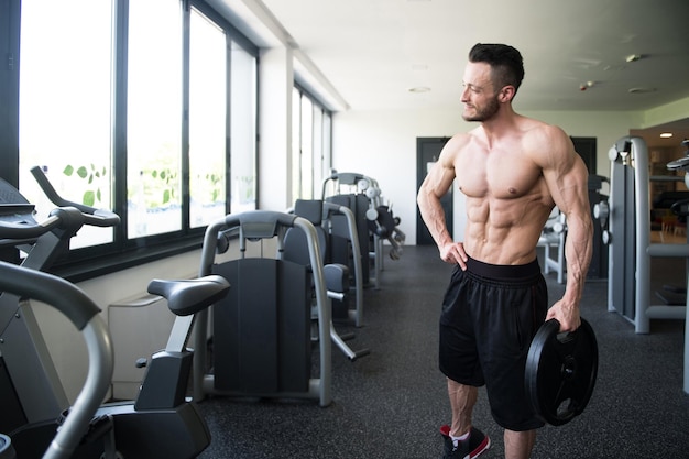 Fit Man Holding Weights In Hand