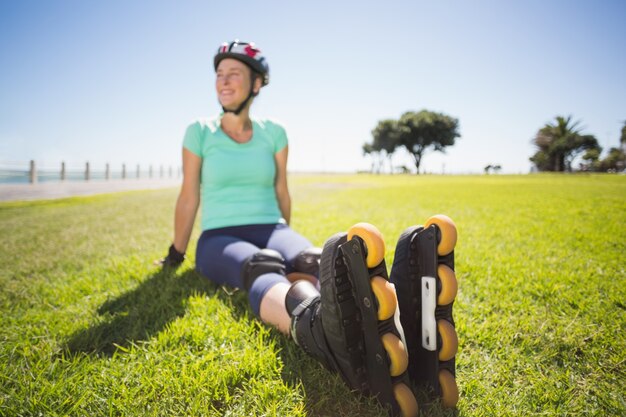 Fit mature woman in roller blades on the grass